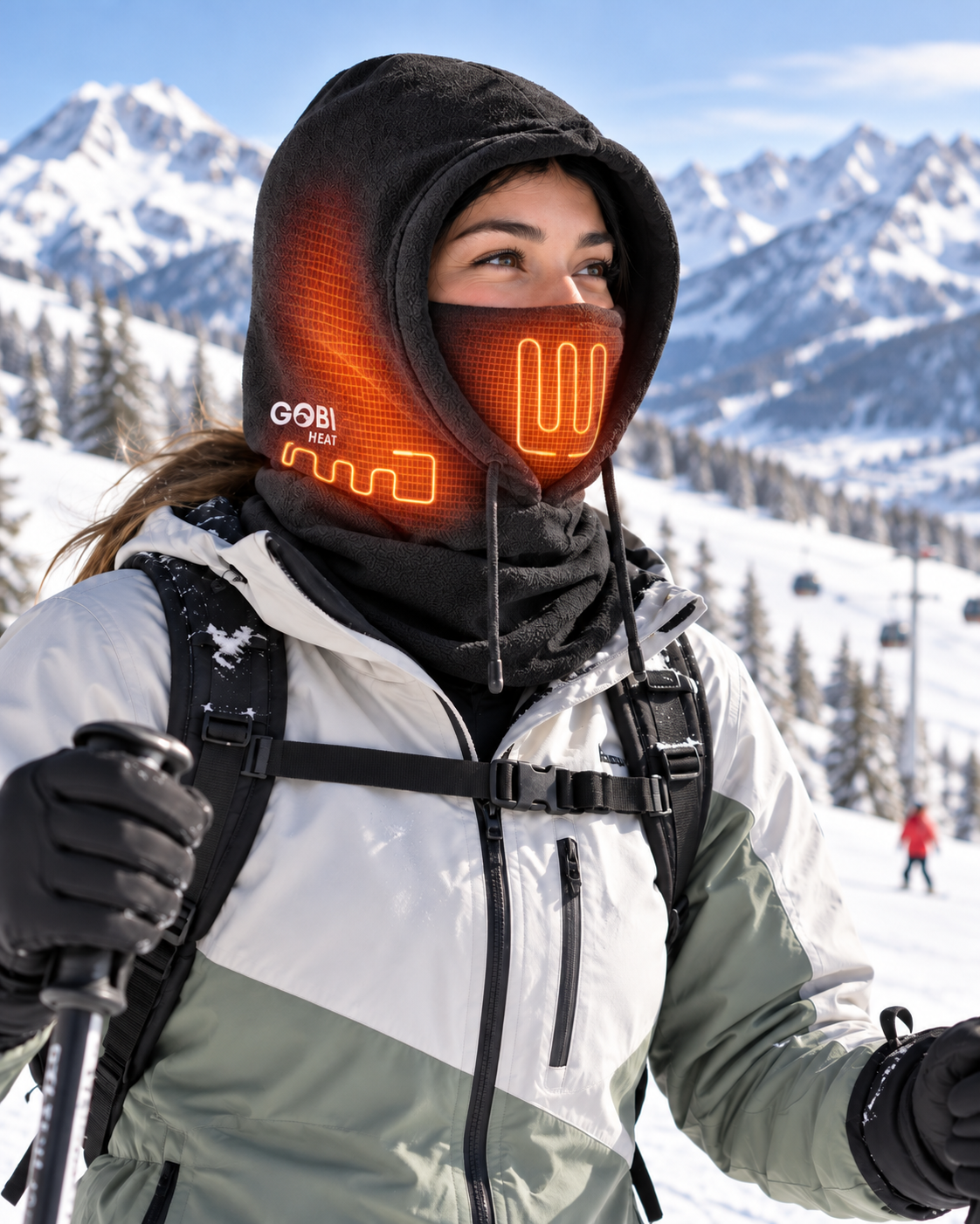 Woman wearing the Squall Heated Balaclava on an alpine slope.