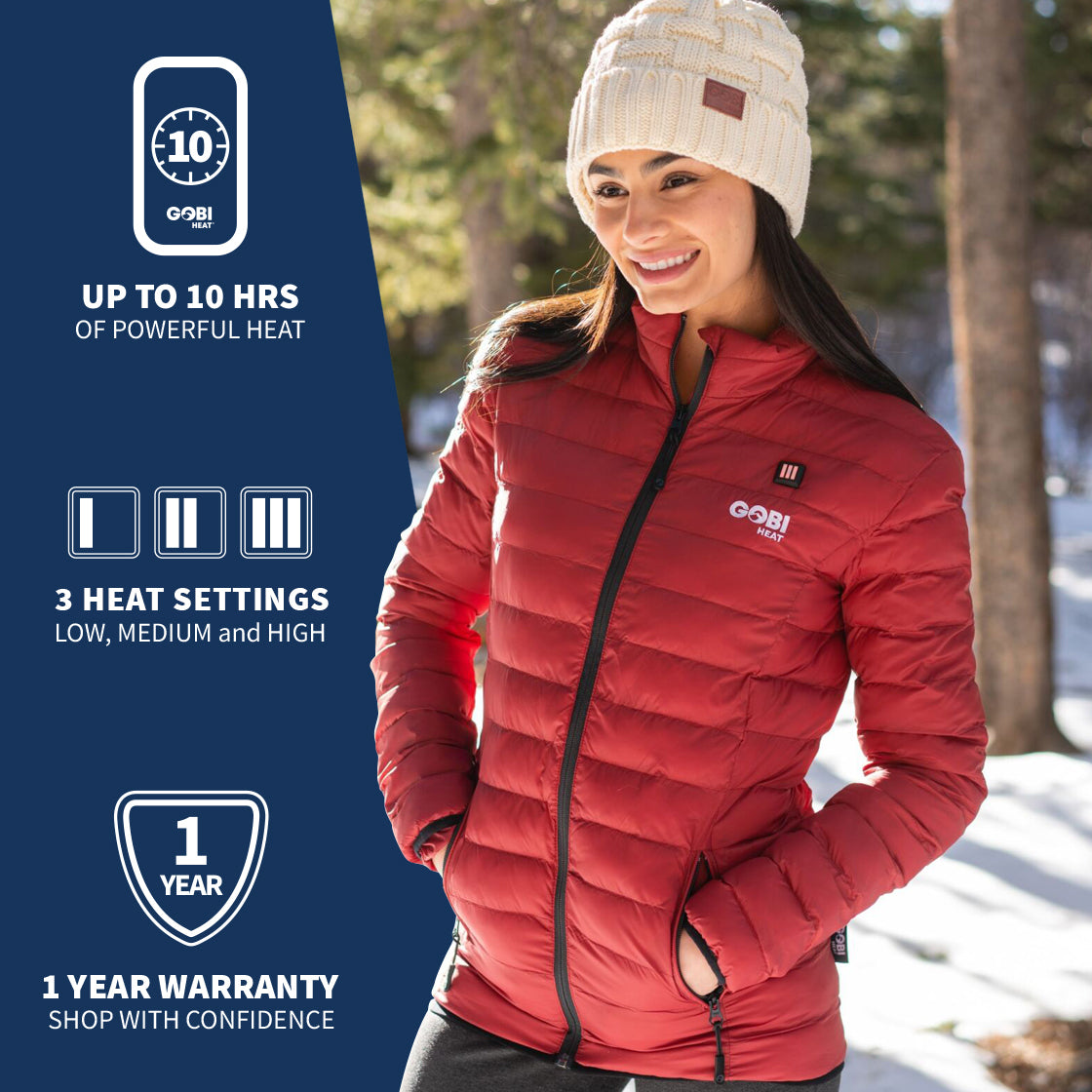 A woman wearing GOBI's women's wolf heated jacket. She is standing in front of a landscape, with information about the product on the left side of the image.
