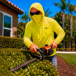 Man in a hi-vis yellow GOBI Helio UPF Sun Hoodie trimming hedges with a gas-powered hedge trimmer in a residential landscape with palm trees in the background.