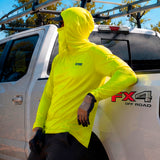 Man in a hi-vis yellow GOBI Helio UPF Sun Hoodie with hood and face cover up, leaning against a Ford FX4 Off Road pickup truck.